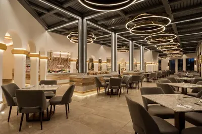 a restaurant with tables and chairs and a bar at Grand Makadi - Couples and Families Only in Hurghada