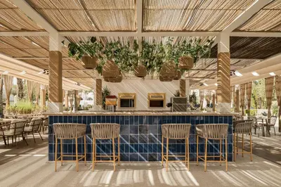 a restaurant with a bar with chairs and tables at Grand Makadi - Couples and Families Only in Hurghada