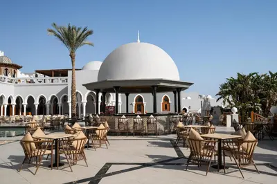 an outdoor patio with tables and chairs and a gazebo at Grand Makadi - Couples and Families Only in Hurghada