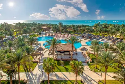 an aerial view of a resort with palm trees and the ocean at Siva Grand Beach in Hurghada