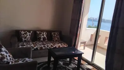 a living room with a couch and a table at Sunny Luxor in Luxor
