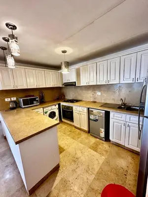 a kitchen with white cabinets and a counter top at New Marina MP 37 in Hurghada