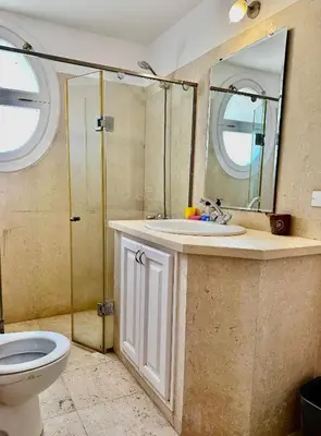 a bathroom with a sink and a toilet and a mirror at New Marina MP 37 in Hurghada