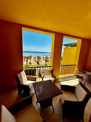 a balcony with a table and chairs and a view of the beach at New Marina MP 37 in Hurghada