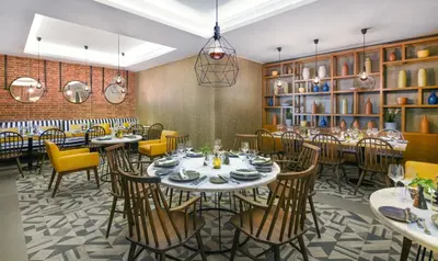 a restaurant with tables and chairs in a room at JAZ Elite Casa Del Mar Beach in Hurghada
