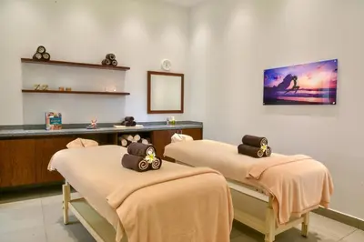 a spa room with three massage beds with towels at JAZ Elite Casa Del Mar Beach in Hurghada