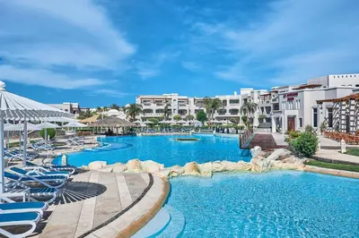 a resort with a large swimming pool with chairs at Iberotel Casa Del Mar Resort in Hurghada