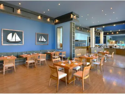 a dining room with wooden tables and chairs at Iberotel Casa Del Mar Resort in Hurghada