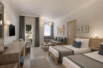 a hotel room with two beds and a living room at Iberotel Casa Del Mar Resort in Hurghada