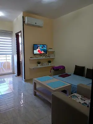 a living room with a couch and a tv at Budget studio near El Gouna and Kite station in Hurghada