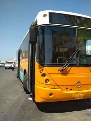 a yellow bus is parked in a parking lot at Budget studio near El Gouna and Kite station in Hurghada