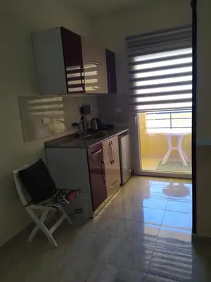 a kitchen with a chair and a sink and a table at Budget studio near El Gouna and Kite station in Hurghada