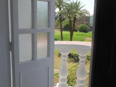 an open door with a view of a table at Cleopatra Hotel Luxor in Luxor