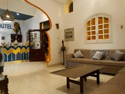 a living room with a couch and a table at Cleopatra Hotel Luxor in Luxor
