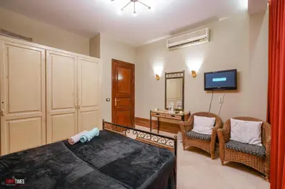 a bedroom with a bed and a living room with a tv at El Gouna 2 bedrooms apartment South Marina Ground Floor in Hurghada