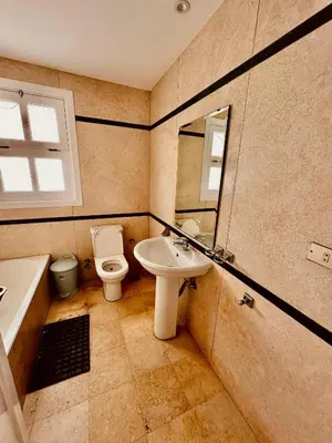 a bathroom with a sink and a toilet and a mirror at Aprtment at Abu Tig Marina - MP6 in Hurghada