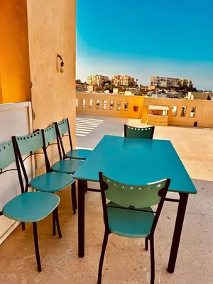 a blue table and chairs on a balcony with a view at Aprtment at Abu Tig Marina - MP6 in Hurghada