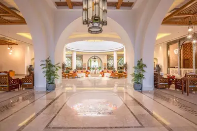 a lobby with a chandelier and a large room at Hilton Marsa Alam Nubian Resort in Abu Dabab