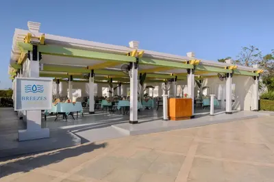 a pavilion with tables and chairs on a patio at Hilton Marsa Alam Nubian Resort in Abu Dabab