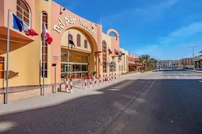 a street with a building with flags on it at Bel Air Azur Resort (Adults Only) in Hurghada