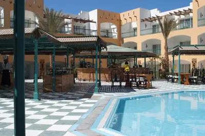 a resort with a swimming pool and a building at Bel Air Azur Resort (Adults Only) in Hurghada