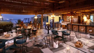 a restaurant with tables and chairs with a view of the ocean at Giftun Azur Resort in Hurghada