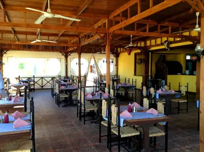 a dining room with tables with pink napkins on them at Giftun Azur Resort in Hurghada