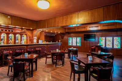 a restaurant with tables and chairs and a bar at Arabia Azur Resort in Hurghada