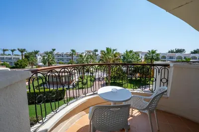 a balcony with a table and chairs on it at JAZ Royal Palmariva in Hurghada