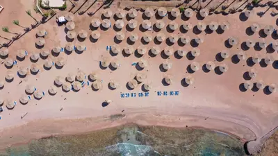 an aerial view of a beach with umbrellas at Blend Club Aqua Resort in Hurghada