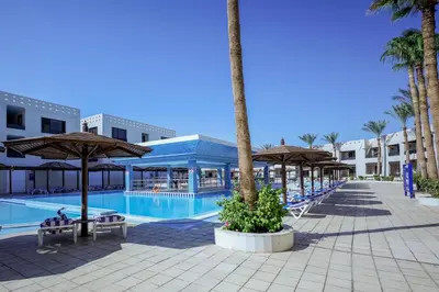 a swimming pool with umbrellas and a resort at Blend Club Aqua Resort in Hurghada
