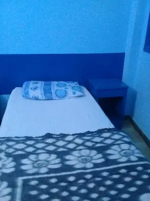 a blue bedroom with a bed with a blue wall at Oasis hotel in Luxor