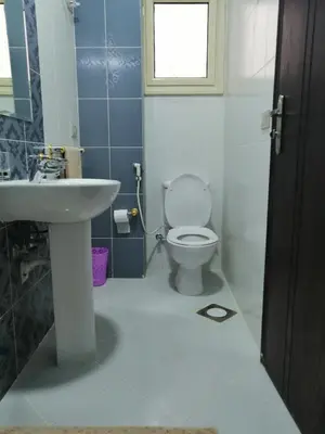 a bathroom with a sink and a toilet and a window at Nour Plaza Hurghada النور بلازا الغردقة in Hurghada