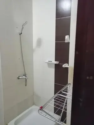 a bathroom with a shower and a bath tub at Nour Plaza Hurghada النور بلازا الغردقة in Hurghada