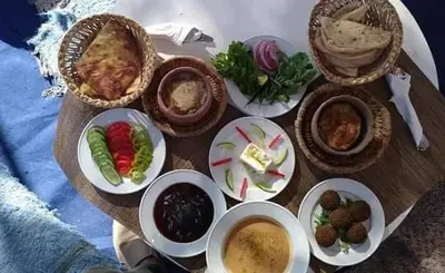a table topped with plates of food and bowls of food at Villa Dream in Luxor