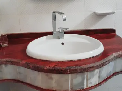 a bathroom with a white sink on a red counter at Villa Dream in Luxor