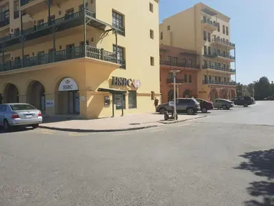 a parking lot with cars parked in front of a building at EL Gouna Abu tig marina studio- economy stay in Hurghada