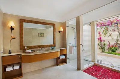 a bathroom with a shower and a sink and a mirror at The Oberoi Beach Resort, Sahl Hasheesh in Hurghada
