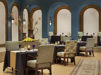 a restaurant with tables and chairs in a room at The Oberoi Beach Resort, Sahl Hasheesh in Hurghada