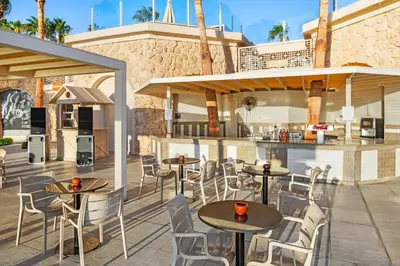 a restaurant with tables and chairs on a patio at Pickalbatros Citadel Resort Sahl Hasheesh in Hurghada