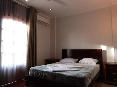a bedroom with a large bed with a window at Luxor Plaza House in Luxor