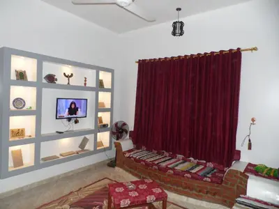 a living room with a couch and a red curtain at Nour House in Luxor