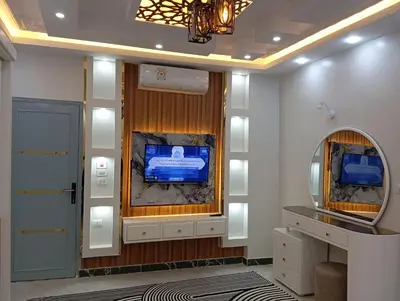a dressing room with a tv and a mirror at Nour House in Luxor
