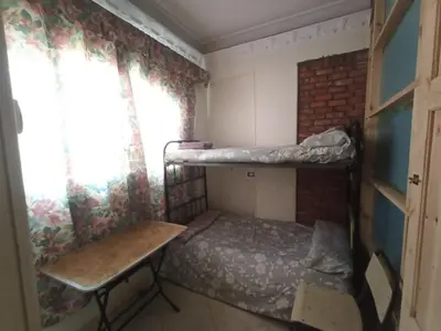 a small room with a bunk bed and a desk at david hostel in Aswan