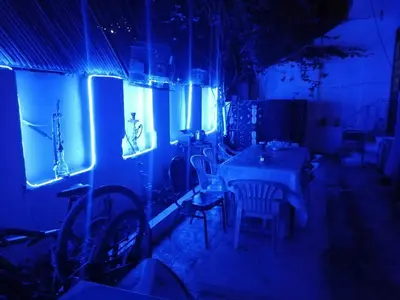 a room with a table and chairs and blue lights at david hostel in Aswan