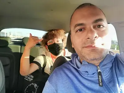 a man sitting in a car wearing a mask at david hostel in Aswan