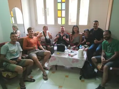 a group of people sitting on a couch at david hostel in Aswan