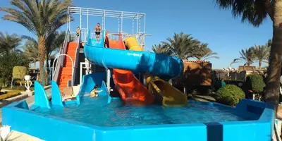 a water slide at a resort with people on it at Sand Beach Resort in Hurghada