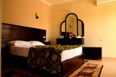 a bedroom with a bed and a large mirror at Sand Beach Resort in Hurghada