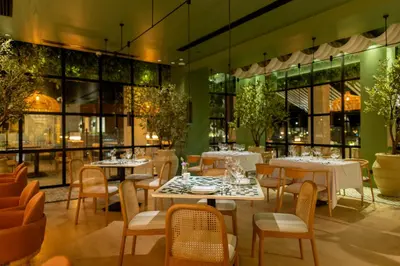 a restaurant with tables and chairs and windows at Desert Rose in Hurghada